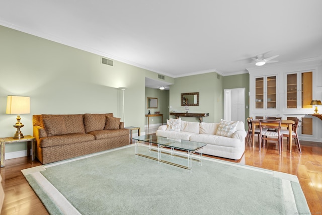 3200 Park Ave Unit 9B1, Bridgeport, CT 06604 - living area with wood finished floors, crown molding, and ceiling fan