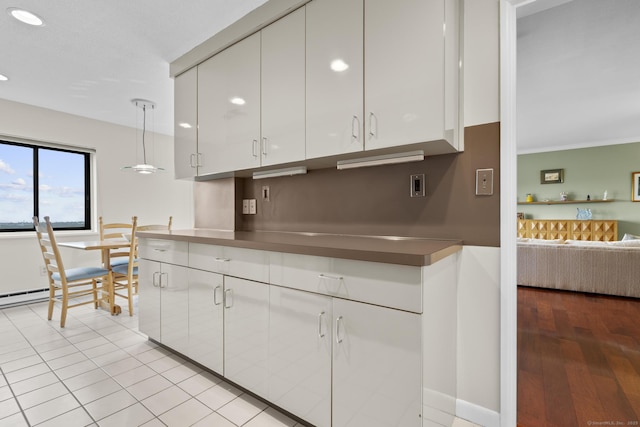3200 Park Ave Unit 9B1, Bridgeport, CT 06604 - kitchen with white cabinets, open floor plan, recessed lighting, ornamental molding, and light wood finished floors