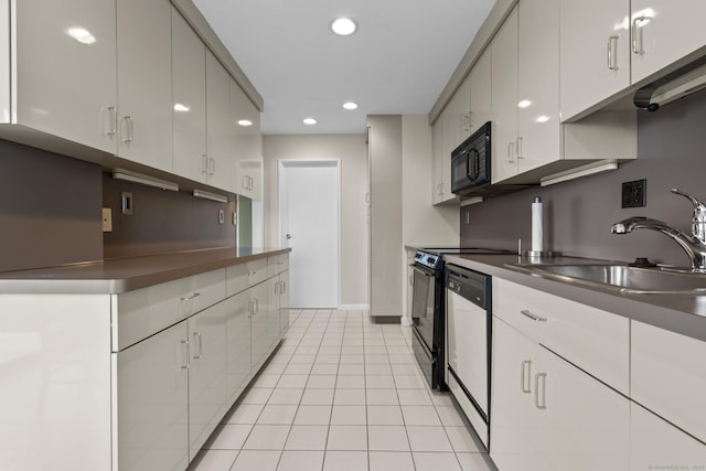 3200 Park Ave Unit 9B1, Bridgeport, CT 06604 - kitchen featuring black appliances, stainless steel countertops, recessed lighting, light tile patterned flooring, and white cabinets