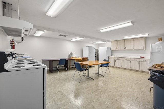 3200 Park Ave Unit 9B1, Bridgeport, CT 06604 - kitchen featuring white appliances, light countertops, and light brown cabinetry