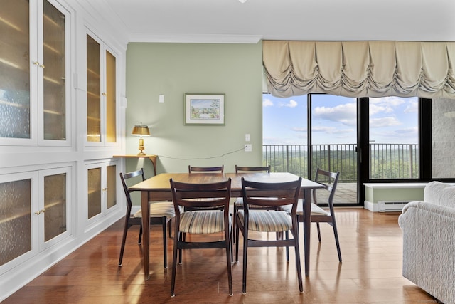 3200 Park Ave Unit 9B1, Bridgeport, CT 06604 - dining room with wood finished floors, healthy amount of natural light, crown molding, and a baseboard radiator