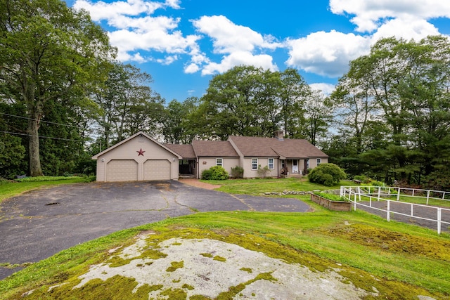 123 Silkey Rd, Granby, CT 06060 - single story home featuring a garage, asphalt driveway, view of wooded area, and a chimney