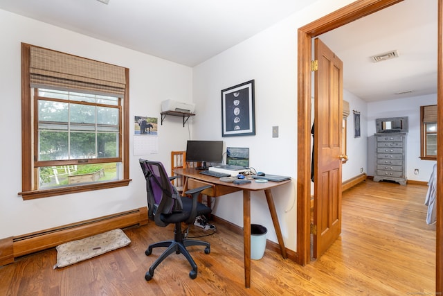 123 Silkey Rd, Granby, CT 06060 - home office featuring baseboard heating, light wood-style flooring, and a wall unit AC