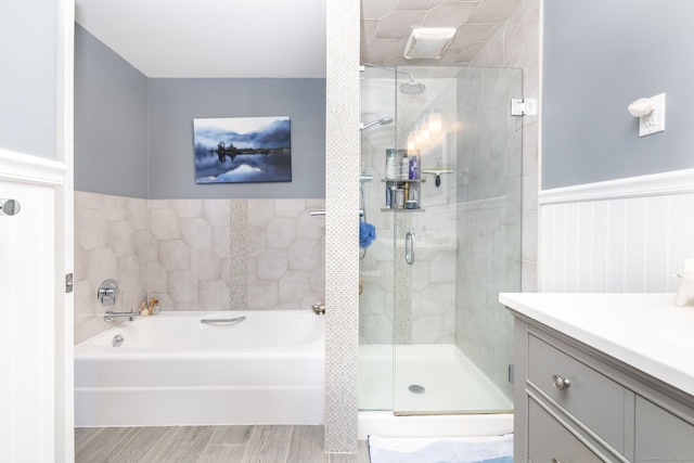 123 Silkey Rd, Granby, CT 06060 - full bathroom with a garden tub, a stall shower, vanity, a wainscoted wall, and wood finished floors