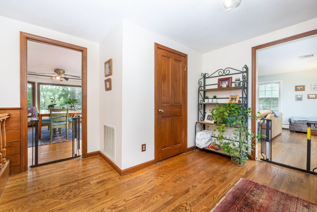 123 Silkey Rd, Granby, CT 06060 - foyer entrance featuring wood finished floors, plenty of natural light, ceiling fan, and a baseboard heating unit