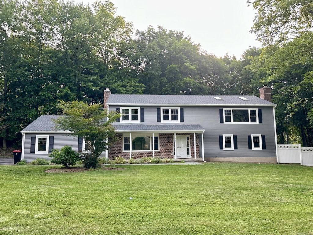 21 Regency Dr, Norwalk, CT 06851 - view of front of home featuring a chimney and a porch