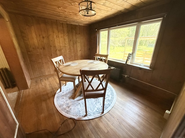 483 Providence Tpke, Hampton, CT 06247 - dining room featuring wooden ceiling, radiator heating unit, hardwood / wood-style floors, and wooden walls
