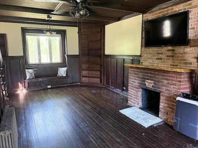 483 Providence Tpke, Hampton, CT 06247 - unfurnished living room with a wainscoted wall, a ceiling fan, dark wood-style floors, a fireplace, and beam ceiling
