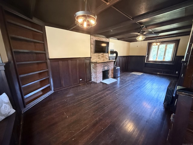 483 Providence Tpke, Hampton, CT 06247 - unfurnished living room featuring wainscoting, a fireplace, ceiling fan, dark wood-type flooring, and beamed ceiling