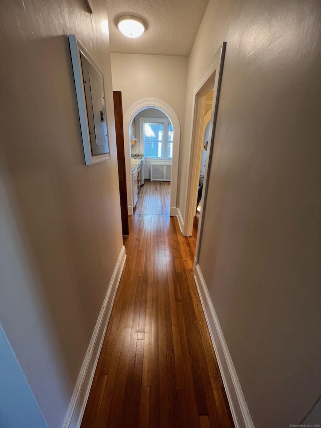 17 Maplewood Ave, West Hartford, CT 06119 - hallway featuring dark wood-style floors, arched walkways, a textured ceiling, and electric panel