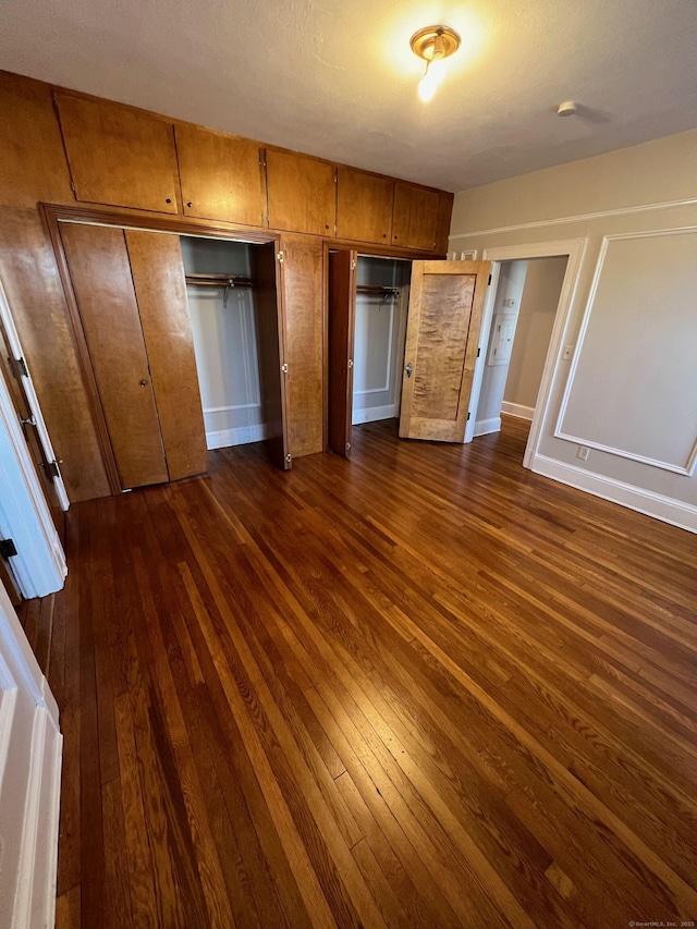 17 Maplewood Ave, West Hartford, CT 06119 - unfurnished bedroom with dark wood-style flooring and multiple closets