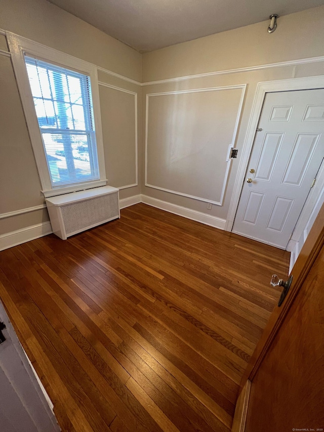 17 Maplewood Ave, West Hartford, CT 06119 - empty room with radiator and dark wood-style flooring