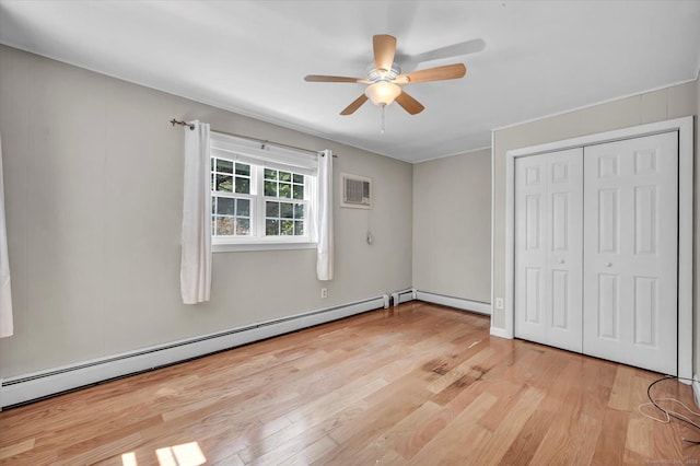 421 Hemlock Point Dr, Coventry, CT 06238 - unfurnished bedroom with light wood-style floors, a wall unit AC, a baseboard radiator, a closet, and ceiling fan