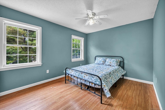 421 Hemlock Point Dr, Coventry, CT 06238 - bedroom with wood finished floors, a textured ceiling, and ceiling fan