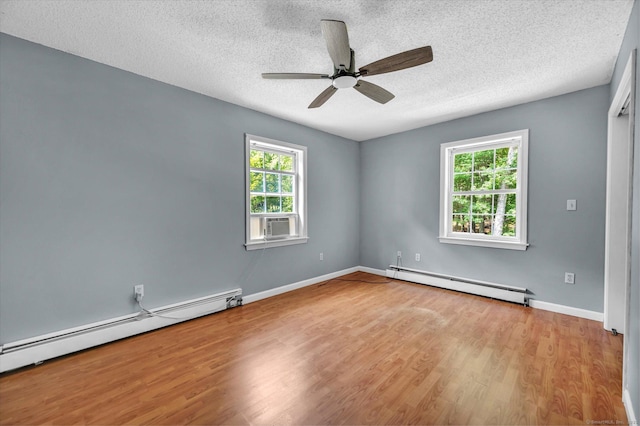 421 Hemlock Point Dr, Coventry, CT 06238 - spare room with baseboard heating, wood finished floors, a textured ceiling, a ceiling fan, and cooling unit