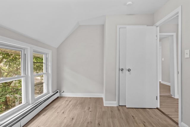 96 Naugatuck Ave, Milford, CT 06460 - additional living space featuring a baseboard radiator, light wood-style flooring, and vaulted ceiling