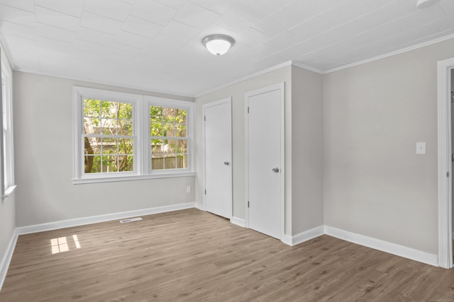 96 Naugatuck Ave, Milford, CT 06460 - unfurnished bedroom featuring wood finished floors and ornamental molding