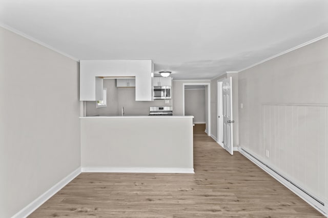 96 Naugatuck Ave, Milford, CT 06460 - kitchen with stainless steel microwave, baseboard heating, stove, white cabinetry, and light wood-type flooring