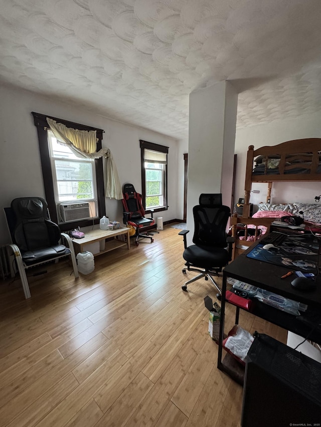 478 E Main St, Norwich, CT 06360 - bedroom with cooling unit, light wood-type flooring, and a textured ceiling