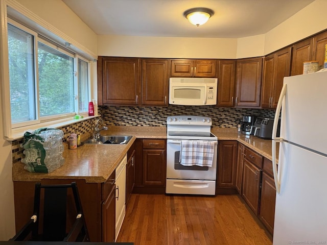 333 Vincellette St Unit 109, Bridgeport, CT 06606 - kitchen with white appliances, wood finished floors, backsplash, and light countertops