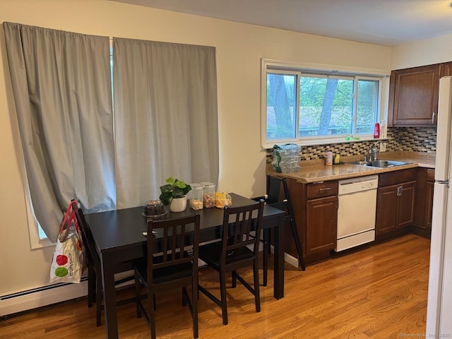 333 Vincellette St Unit 109, Bridgeport, CT 06606 - kitchen with white appliances, light wood finished floors, light countertops, tasteful backsplash, and dark brown cabinetry