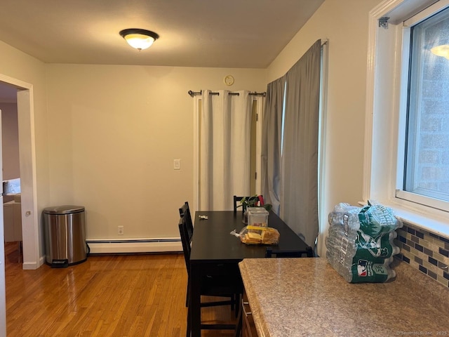 333 Vincellette St Unit 109, Bridgeport, CT 06606 - dining space featuring a baseboard radiator and wood finished floors