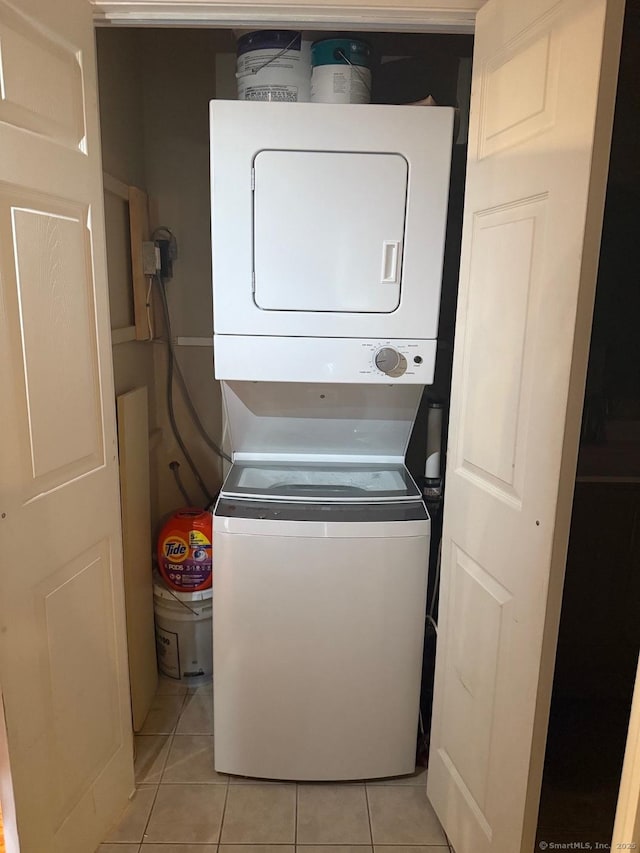 333 Vincellette St Unit 109, Bridgeport, CT 06606 - washroom with stacked washing machine and dryer and light tile patterned floors