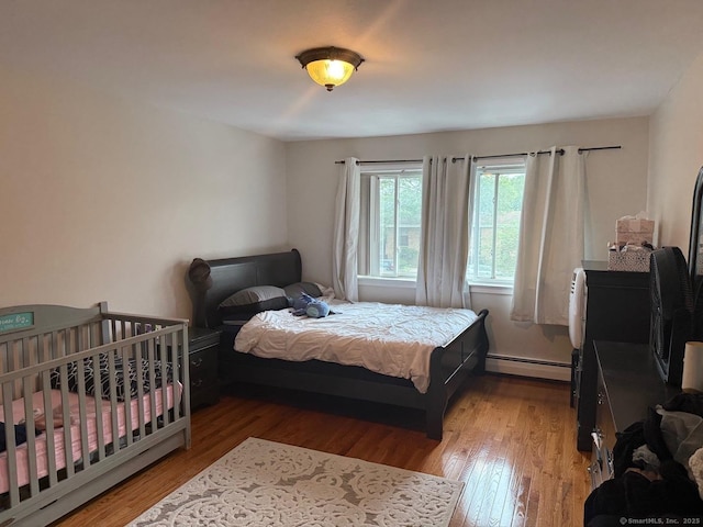 333 Vincellette St Unit 109, Bridgeport, CT 06606 - bedroom featuring a baseboard radiator and wood finished floors