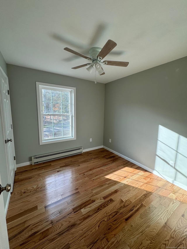446G Norwich-Westerly Rd, North Stonington, CT 06359 - empty room featuring a baseboard heating unit, wood finished floors, and a ceiling fan