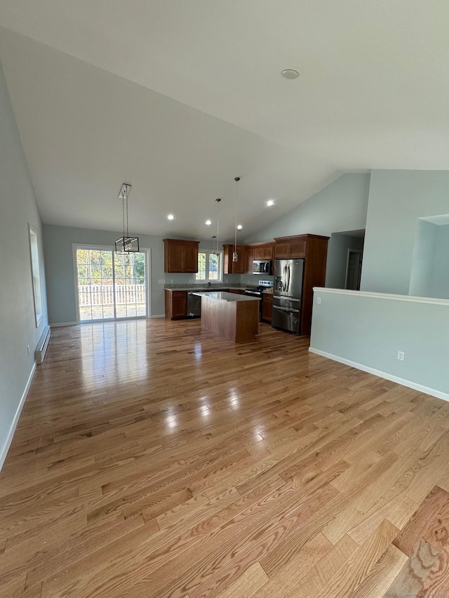 446G Norwich-Westerly Rd, North Stonington, CT 06359 - kitchen featuring stainless steel appliances, open floor plan, vaulted ceiling, a kitchen island, and light wood finished floors