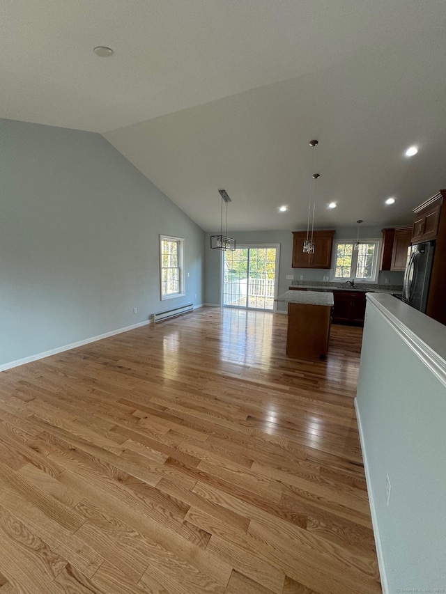 446G Norwich-Westerly Rd, North Stonington, CT 06359 - unfurnished living room featuring baseboard heating, light wood-type flooring, recessed lighting, vaulted ceiling, and a chandelier