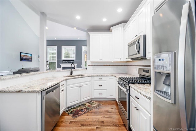 17 Brookside Ct Unit 17, Newtown, CT 06470 - kitchen with stainless steel appliances, white cabinets, light wood-style floors, recessed lighting, and light stone countertops