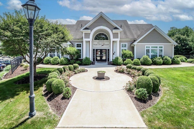 17 Brookside Ct Unit 17, Newtown, CT 06470 - view of front facade featuring french doors, a front lawn, and a shingled roof