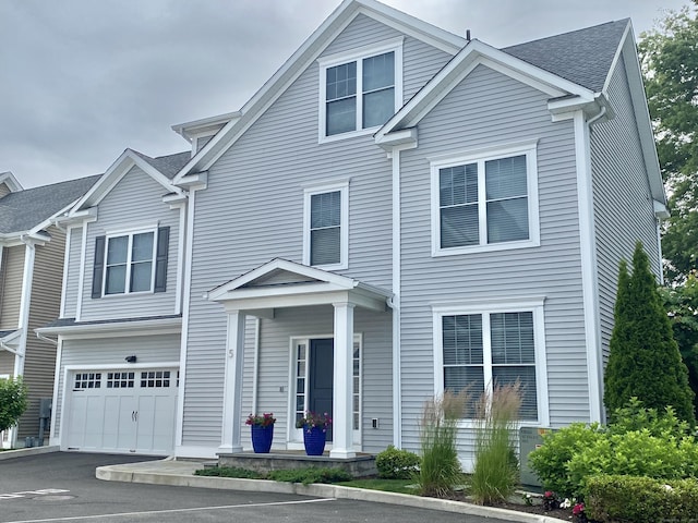 159 Colonial Rd Unit 5, Stamford, CT 06906 - traditional-style home with a garage, a shingled roof, and driveway