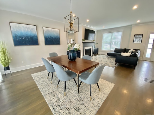 159 Colonial Rd Unit 5, Stamford, CT 06906 - dining room featuring dark wood-type flooring, crown molding, a fireplace, and recessed lighting