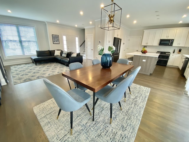 159 Colonial Rd Unit 5, Stamford, CT 06906 - dining area with crown molding, stairs, light wood-style floors, and a chandelier