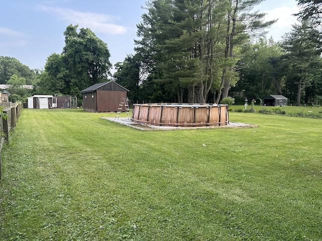 42 Tromley Rd, East Windsor, CT 06088 - view of yard featuring a storage shed, an outdoor pool, and view of wooded area