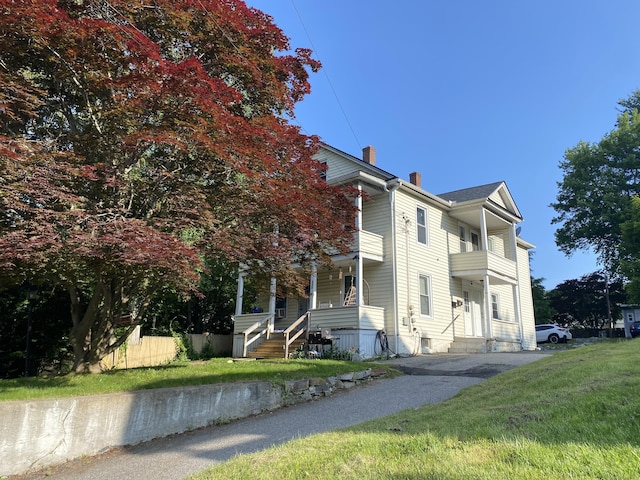 114 Pulaski St, Torrington, CT 06790 - view of property exterior with a chimney, a balcony, and driveway