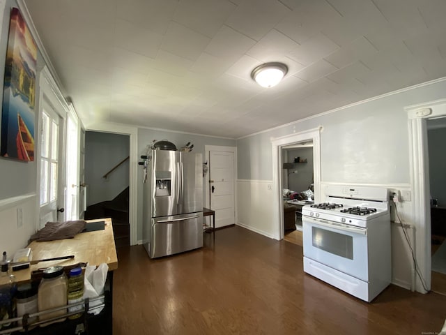 114 Pulaski St, Torrington, CT 06790 - kitchen featuring gas range gas stove, stainless steel fridge with ice dispenser, ornamental molding, dark wood-type flooring, and a wainscoted wall