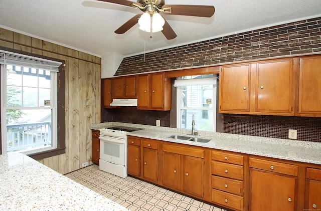 34 Hobart St, Meriden, CT 06450 - kitchen featuring white range with electric stovetop, under cabinet range hood, brown cabinets, decorative backsplash, and light floors