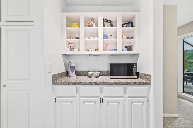 17 Font Hill Park Unit 17, Bloomfield, CT 06002 - kitchen with stainless steel microwave, carpet flooring, white cabinets, open shelves, and light stone countertops