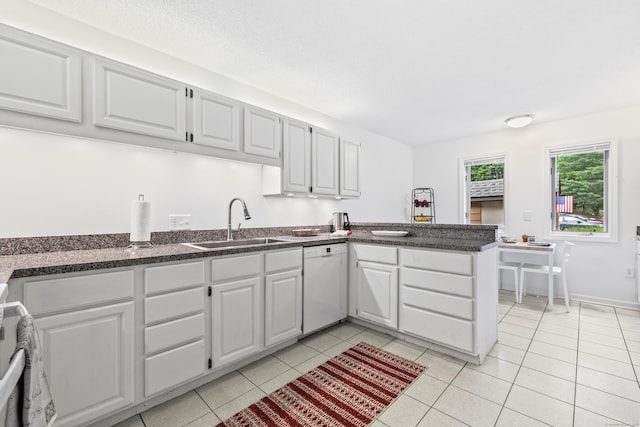17 Font Hill Park Unit 17, Bloomfield, CT 06002 - kitchen with white dishwasher, a peninsula, dark countertops, white cabinets, and light tile patterned floors