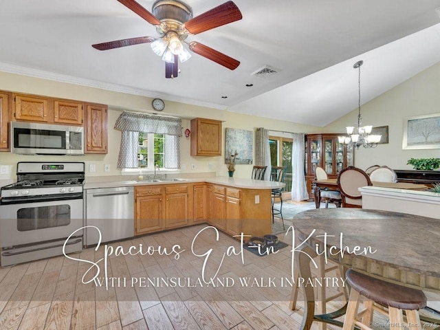 7 Sylvan Rd, Danbury, CT 06811 - kitchen with stainless steel appliances, a peninsula, vaulted ceiling, light countertops, and a chandelier