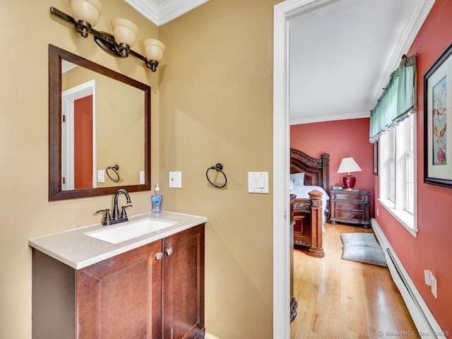 7 Sylvan Rd, Danbury, CT 06811 - bathroom with baseboard heating, crown molding, wood finished floors, and vanity