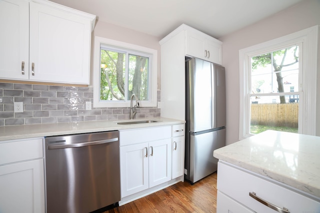 30 Ward Pl, West Haven, CT 06516 - kitchen with stainless steel appliances, plenty of natural light, decorative backsplash, and wood finished floors