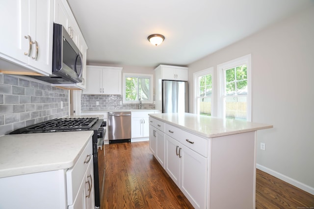 30 Ward Pl, West Haven, CT 06516 - kitchen with stainless steel appliances, tasteful backsplash, dark wood finished floors, and light countertops