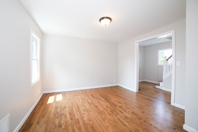 30 Ward Pl, West Haven, CT 06516 - empty room with wood finished floors and stairway