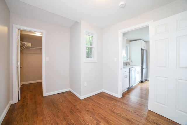 30 Ward Pl, West Haven, CT 06516 - unfurnished bedroom featuring freestanding refrigerator, wood finished floors, a spacious closet, and a closet