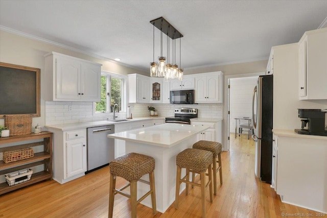 15 Thompson Hill Rd, Canton, CT 06019 - kitchen with appliances with stainless steel finishes, a kitchen bar, white cabinetry, a center island, and crown molding