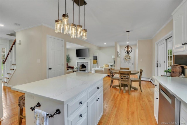15 Thompson Hill Rd, Canton, CT 06019 - kitchen with dishwasher, light wood-style floors, a chandelier, a fireplace, and white cabinets